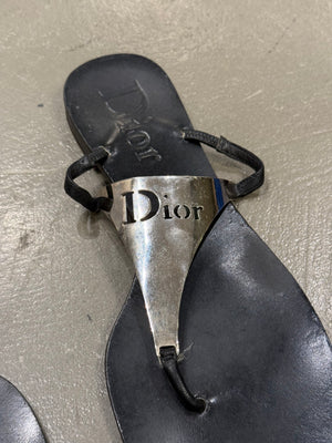 2000s Dior by John Galliano leather flip-flops with metallic plaque